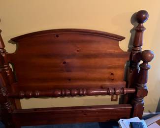 Solid wood queen bed has mattress and box springs. 