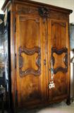Antique Walnut armoire. Carved Lion at top.