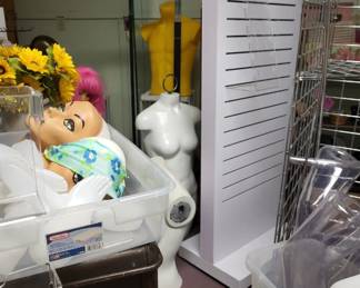 White slatwall turnstyle rack, maniquins, clothing racks and fixtures galore.