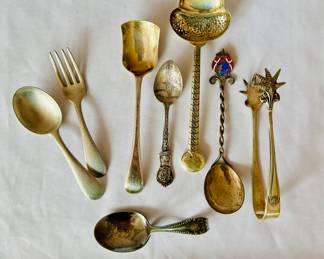 Vintage silver baby set (L), miscellaneous serving pieces, and souvenir spoons