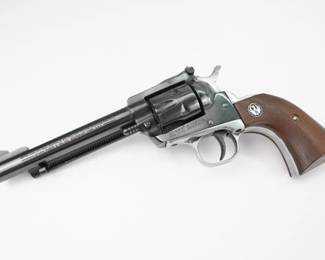 The Ruger Single-Six is a single-action rimfire revolver produced by Sturm, Ruger & Co. The Single-Six was first released in June 1953. The Single-Six is currently produced as the New Model Single-Six. The term "New Model" simply means that this model includes Ruger's transfer bar mechanism for increased safety, allowing one to carry the revolver safely with all six chambers loaded. Prior to 1973, the Single-Six was produced without the transfer bar mechanism, making it less safe to carry with all six chambers loaded, and with the hammer resting on a loaded chamber. The transfer bar safety allows the revolver to fire only when the trigger has been pulled. Ruger provides the transfer bar safety upgrade free of charge for owners of any old model Single-Six, though this may come with a significant trigger-feel penalty. This revolver is in excellent condition showing normal signs of use and wear.