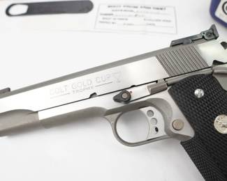 The Colt Gold Cup is known as the finest shooting semi-automatic in the world, and it is the standard for competitive guns. The Gold Cup Trophy features an adjustable wide trigger, national match barrel, and fully-adjustable Bomar-style rear sight. This pistol also features wrap-around rubber stocks with nickel medallions and an upswept beavertail grip safety. This pistol was manufactured in 2000 and is sold with the factory box and two magazines. The pistol also included a switch activated red laser. The firearm is in excellent condition, showing minimal signs of use and wear.