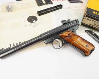 Here we have a very nice Ruger MkII Target pistol in .22 long rifle caliber. The MK II ("Mark Two") was made from 1982 to 2005. It replaced the Standard, Ruger's first model, made from 1949 to 1982, and the MK I Target, made from 1951 to 1982. MK II variations include the Target models, which have heavier barrels and adjustable sights, and the 22/45 models, which have a polymer frame with a grip-angle that matches the Colt 1911 rather than the steel frame's Luger P08–like layout. Being a Mark II it has a heel style magazine release. This pistol is in excellent condition showing normal signs of use and wear. 