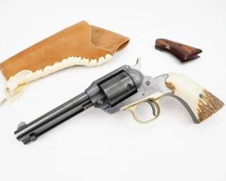 The Ruger Bearcat is a single-action, .22 caliber revolver manufactured by Sturm, Ruger & Co., introduced in 1958. It is based on the classic Remington single-action revolvers of the mid-19th century. This Bearcat is dated back to 1961 based on the serial number 13730. The revolver is fitted with a set of custom antler grips and comes with a custom holster and factory wooden grips. The revolver is in excellent condition, showing normal signs of use and wear. 