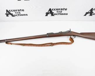 Manufactured in 1885, this is a vintage Springfield 1878 Trapdoor rifle chambered in 45-70 Government. It features a 32-inch barrel, trapdoor action, adjustable rear rifle sight, sling loops, and steel buttplate. The rifle is fitted with a sling and overall is in excellent condition, showing normal signs of use and wear. 