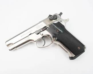 NICKEL FINISH. The Model 59 was designed for the U.S. Navy as a large-capacity version of the S&W Model 39, the basis of their Mark 22 "Mark 22 Hush Puppy" suppressed pistol. In 1965, the U.S. Navy commissioned a version of the S&W Model 39 that could take the 13-round magazine of the Browning Hi-Power. In early 1970, a dozen experimental all-stainless-steel prototypes were made and were issued to Navy SEAL commandos for evaluation in the field, but it was not adopted.The Model 59 went on the market in 1971.It went out of production a decade later in 1982 when the improved second generation series was introduced (the Model 459). .This pistol is in excellent condition showing normal signs of use and wear.