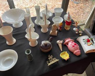 Table of collectible glass, lots of milk glass. 
