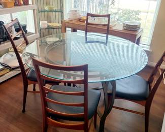 •Wrought-iron base round glass table
• 4 Danish Teak ladder back chairs
• sofa/entry table in back ground 