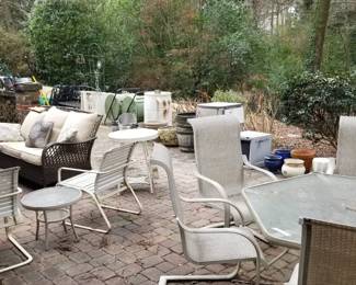 Entire patio filled with furniture in good shape. Two umbrellas, two composters, so many large pots. Foldable aluminum fencing, hoses, 3 leaf-blowers, tools.