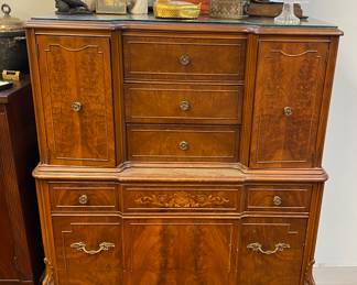Ornate chest of drawers with multiple cabinets and drawers 