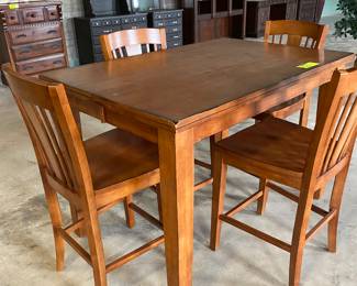 Wooden pub table with expandable top and four chairs