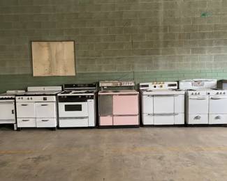 7 antique stoves from various eras.  Unknown whether working.   Received on trade in appliance business.