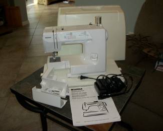 Kenmore Sewing Machine Model #385 with accessories and cover.
