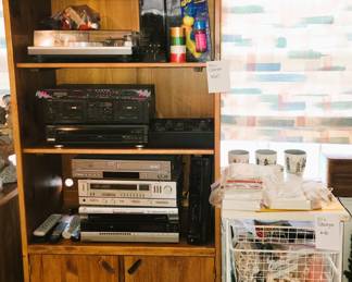 Retro storage shelves with stereo electronics and turntable. Elfa storage cabinet with wood top