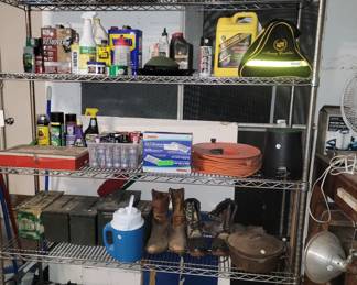Stainless shelving: pipe wrenches, cast iron Dutch oven with lid, lawn and garden and household products