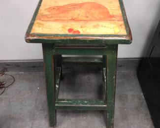 Solid wood stool with money on top.