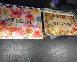 Quite a few brand new welcome mats with tags.
