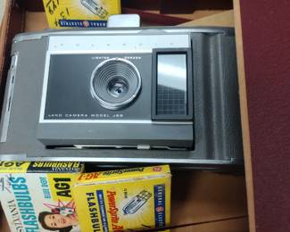 Vintage Polaroid Land camera with carrying case paperwork and bulbs.