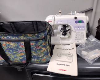 Janome Model DC3050 sewing machine with paperwork and carrying case.