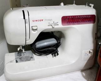 Singer Sewing machine with instruction manual.