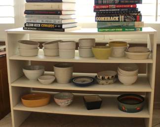3-tier white shelf with kitchen glassware and various books