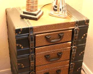 Great trunk/suitcase looking bedside table dresser. There are 2 matching dressers with 2 matching wicker lamps.