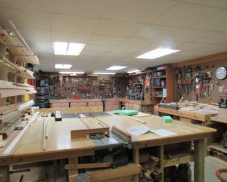 Impeccably organized and fully stocked, this large basement workshop has EVERYTHING  a wood worker needs.