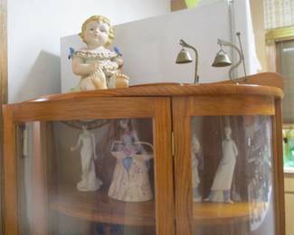 Curved glass china case filled with figurines