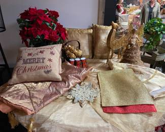 Golden accented table with tree skirts, pillows, reindeer, stocking hangers, tree topper and more!!