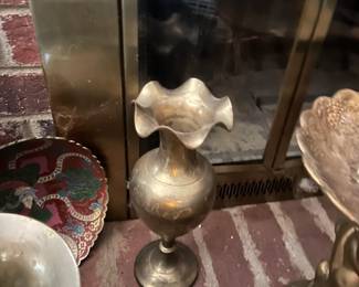 A beautiful solid brass bud vase. It features a ruffled rim and stands approx. 10" tall. It is marked "Made in India".
