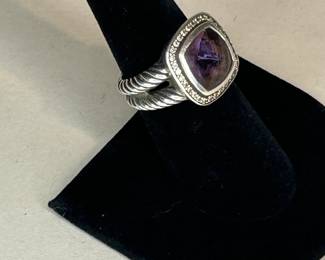 PRODUCT DETAILS
The Albion® Collection’s unique cushion-cut center stone was David Yurman’s innovative solution to use an oversize gemstone in a refined modern setting with classical proportions.
Sterling silver
Black Orchid (lavender amethyst backed with hematine), 8.30 total carat weight
Stone, 14mm
Pavé diamonds, 0.35 total carat weight
Ring, 18mm
This item can be resized by visiting any David Yurman Store.
Style Number: R12454DSSAAHDI
CARE
METAL: Use the white side of the provided David Yurman polishing cloth to wipe clean gently, then remove any remaining tarnish with mild diluted soap. Rinse with warm water and dry thoroughly before storing the design in its jewelry pouch.
GEMSTONE: Avoid contact with perfumes, hairspray, or other chemicals. Clean with a moistened cloth. Do not use chemical jewelry cleaners.