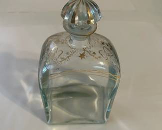 Vintage Liquor Bottle from Jerez, Spain, Gild Decorated at the Top, Ribbons & Stars, with Glass Topper, Decanter Style, in Mint Condition. It is a glass liquor bottle with a glass top. The stopper and upper part of the bottle are decorated in hand-painted gold in grapes and ribbon pattern.
This decanter was purchased new in the 1970s during travel and remained with the original owner. She is downsizing and is now available for purchase.
Disclosures: This pristine decanter is in excellent condition with normal signs of wear for a piece of this age, although it has NO cracks or chips. (Please see the pictures for details.)
Dimensions: 4.25" Width x 2.5" Depth x 8.25" Height
Weight: 1.15 Pounds