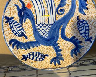 A superb hand-painted charger plate, made in Spain in the twentieth century and depicts a stunning stylized dragon in cobalt blue against a hand-painted background pattern it's a good size, too at 30 Cm or 12” across
