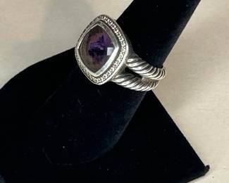 PRODUCT DETAILS
The Albion® Collection’s unique cushion-cut center stone was David Yurman’s innovative solution to use an oversize gemstone in a refined modern setting with classical proportions.
Sterling silver
Black Orchid (lavender amethyst backed with hematine), 8.30 total carat weight
Stone, 14mm
Pavé diamonds, 0.35 total carat weight
Ring, 18mm
This item can be resized by visiting any David Yurman Store.
Style Number: R12454DSSAAHDI
CARE
METAL: Use the white side of the provided David Yurman polishing cloth to wipe clean gently, then remove any remaining tarnish with mild diluted soap. Rinse with warm water and dry thoroughly before storing the design in its jewelry pouch.
GEMSTONE: Avoid contact with perfumes, hairspray, or other chemicals. Clean with a moistened cloth. Do not use chemical jewelry cleaners.