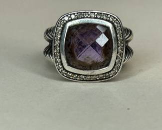 PRODUCT DETAILS
The Albion® Collection’s unique cushion-cut center stone was David Yurman’s innovative solution to use an oversize gemstone in a refined modern setting with classical proportions.
Sterling silver
Black Orchid (lavender amethyst backed with hematine), 8.30 total carat weight
Stone, 14mm
Pavé diamonds, 0.35 total carat weight
Ring, 18mm
This item can be resized by visiting any David Yurman Store.
Style Number: R12454DSSAAHDI
CARE
METAL: Use the white side of the provided David Yurman polishing cloth to wipe clean gently, then remove any remaining tarnish with mild diluted soap. Rinse with warm water and dry thoroughly before storing the design in its jewelry pouch.
GEMSTONE: Avoid contact with perfumes, hairspray, or other chemicals. Clean with a moistened cloth. Do not use chemical jewelry cleaners.