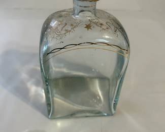 Vintage Liquor Bottle from Jerez, Spain, Gild Decorated at the Top, Ribbons & Stars, with Glass Topper, Decanter Style, in Mint Condition. It is a glass liquor bottle with a glass top. The stopper and upper part of the bottle are decorated in hand-painted gold in grapes and ribbon pattern.
This decanter was purchased new in the 1970s during travel and remained with the original owner. She is downsizing and is now available for purchase.
Disclosures: This pristine decanter is in excellent condition with normal signs of wear for a piece of this age, although it has NO cracks or chips. (Please see the pictures for details.)
Dimensions: 4.25" Width x 2.5" Depth x 8.25" Height
Weight: 1.15 Pounds