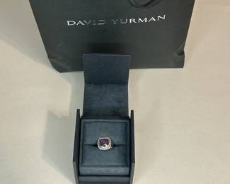 PRODUCT DETAILS
The Albion® Collection’s unique cushion-cut center stone was David Yurman’s innovative solution to use an oversize gemstone in a refined modern setting with classical proportions.
Sterling silver
Black Orchid (lavender amethyst backed with hematine), 8.30 total carat weight
Stone, 14mm
Pavé diamonds, 0.35 total carat weight
Ring, 18mm
This item can be resized by visiting any David Yurman Store.
Style Number: R12454DSSAAHDI
CARE
METAL: Use the white side of the provided David Yurman polishing cloth to wipe clean gently, then remove any remaining tarnish with mild diluted soap. Rinse with warm water and dry thoroughly before storing the design in its jewelry pouch.
GEMSTONE: Avoid contact with perfumes, hairspray, or other chemicals. Clean with a moistened cloth. Do not use chemical jewelry cleaners.