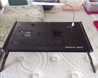 WAS STILL IN PLASTIC WHEN I FOUND IT. SHARPER IMAGE LAPTOP STAND FOR IN BED.