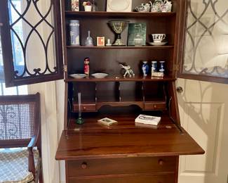 Secretary is in excellent condition filled with Wedgewood, Holland art, Asian collectibles from years of travels.