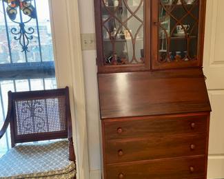 Beautiful secretary and arm chair with cane back and upholstered seat.