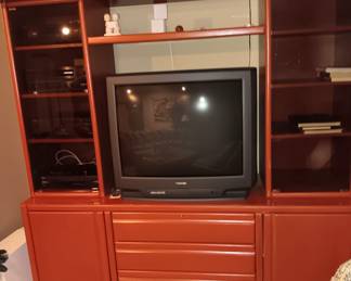 Large burnt orange entertainment center, 80"L x 25"W x 78"H. very good condition, made by Baker Road. Was *$365.00* now $265.00.