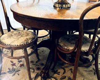 Claw footed antique table and bent-wood chairs. 