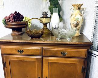 Antique lanterns, amber glassware, antique buffet and really great plants here.