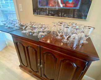 Server heat protectant top flips open on both side for serving suggestions.  Crystal stemware, Water, wines and coso/martini's with a silver rim.