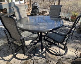Metal patio table and swivel chairs