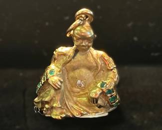 Gold, emerald and a single diamond pendant.