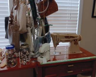 Singer in cabinet. Collection of buttons 
