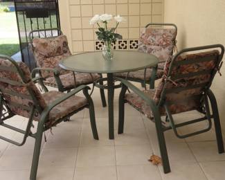 Patio table/chairs and cushions.