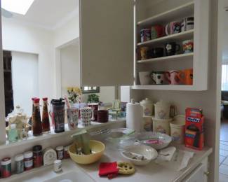 Starbucks coffee mugs, storage cannisters, mixing bowls.