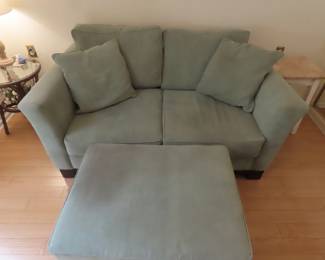 Comfy loveseat and ottoman.